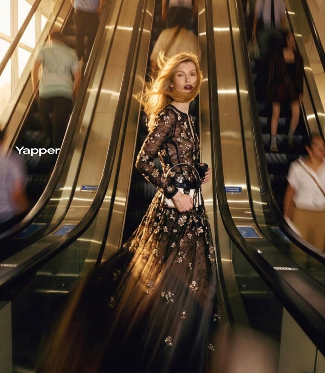 Ultra-realistic cinematic fashion photograph of a stylish blonde woman standing confidently between two moving escalator