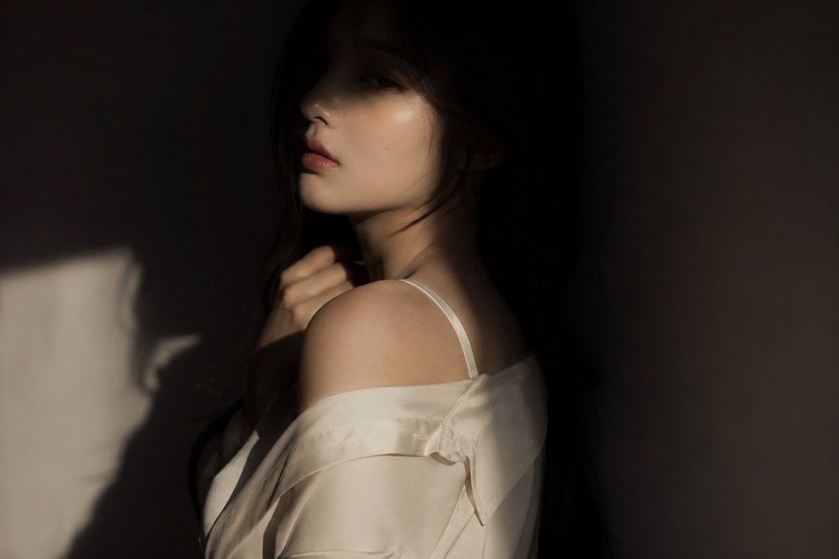 editorial portrait, Korean female idol, subtly sensual  outfit: silk shirt or soft fabric top, slightly loose, elegant a