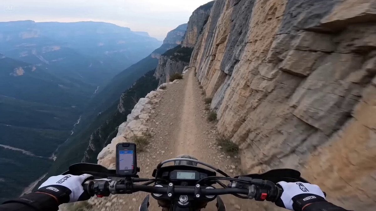 Character First-person POV of a motorcycle rider, hands gripping handlebars tigh…