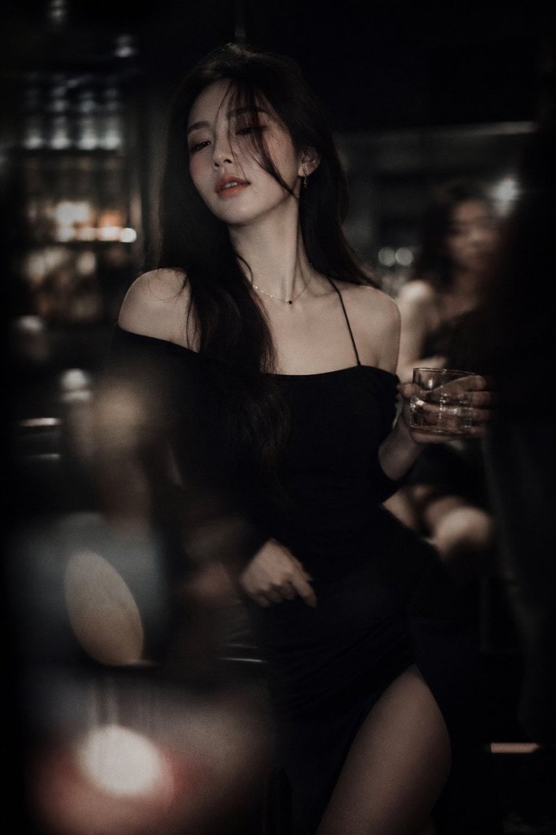 Low-light cinematic portrait, telephoto lens compression, shallow depth of field…