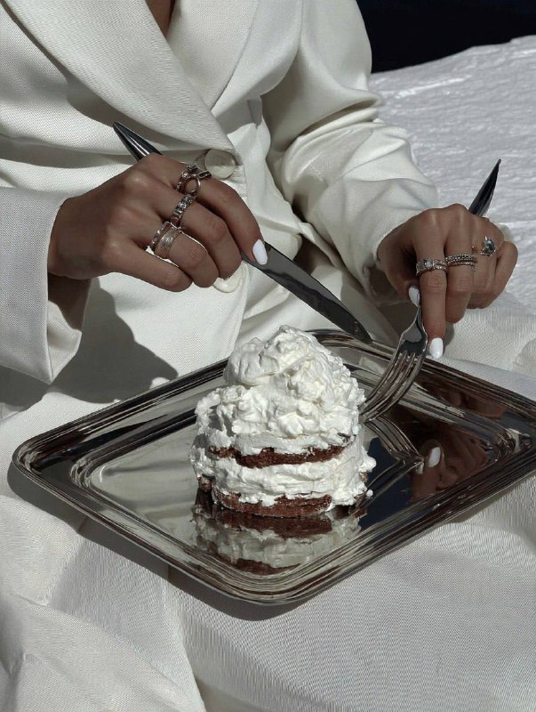 editorial shot of hands with lots of rings holding knife and fork near stainless… (1)