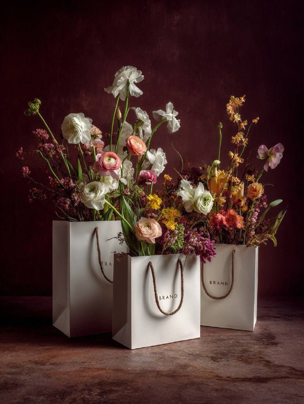 A photorealistic still life photograph of three elegant white luxury shopping ba…