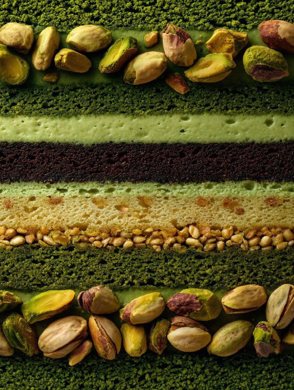 Extreme close-up cross-section of a layered matcha and chocolate cake shot from …