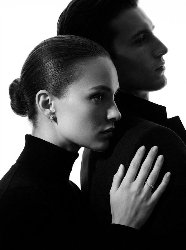 Black-and-white high fashion jewelry editorial photograph featuring two models Γ…