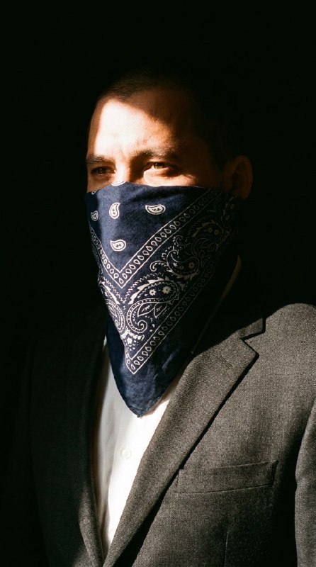 Portrait of a person, wearing in classic Dior business suit witch bandana on fac…